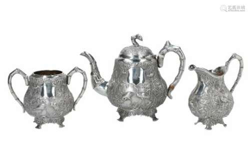 A three-piece silver tea service, decorated with birds and bamboo. Total weight approx. 984 g.