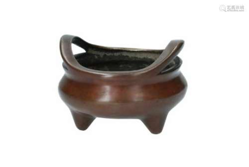 A bronze tripod censer with two handles. Marked with seal mark Xuande. China, Qing. Total weight