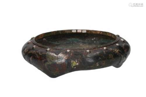 A bronze tripod censer, decorated in relief with dragons. Unmarked. China, 18th century. Total