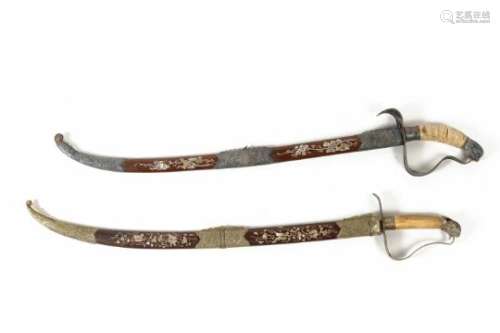 Two swords with copper mounting. One with bone handle and wooden scabbard and mother of pearl inlay,