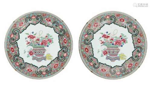 A pair of famille rose porcelain chargers, decorated with flowers and a flower vase. Unmarked.