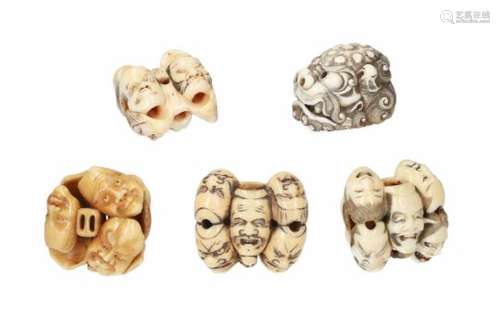 Lot of five netsuke, 1) ivory, shishi head. Signed Tomotada. H. 3 cm. 2) ivory, seven masks incl. an