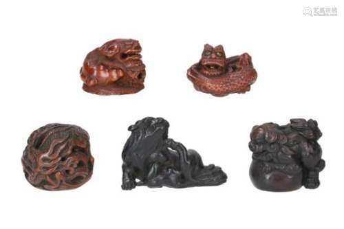 Lot of five netsuke, 1) wood, curled up dragon in the clouds, with moving ball inside. H. 3.5 cm. 2)