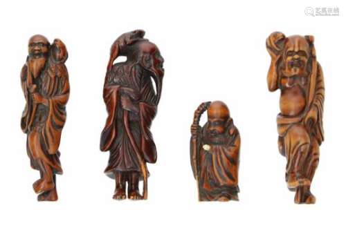 Lot of four netsuke, 1) wood, standing Gama Sennin with staff and toad. H. 9.5 cm. 2) wood, standing