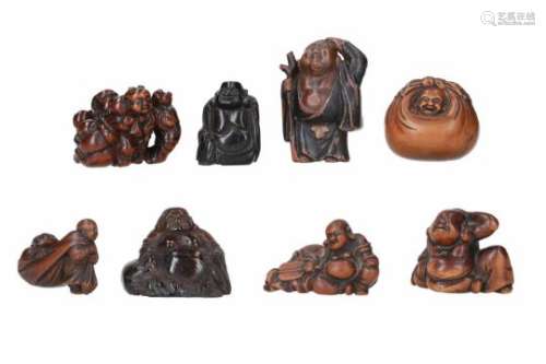 Lot of eight netsuke, 1) wood, standing Hotei with staff. H. 5 cm. 2) boxwood, sitting Hotei. H. 3.5