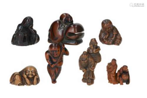 Lot of seven netsuke, 1) wood, kneeling priest with mokugyo. L. 5 cm. 2) wood, standing Kensu