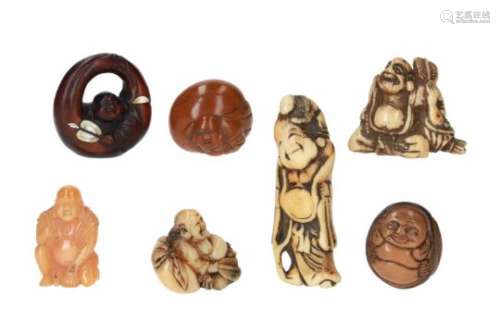 Lot of seven netsuke, 1) stag antler, sitting Hotei with fan. H. 4 cm. 2) hornbill beak, sitting