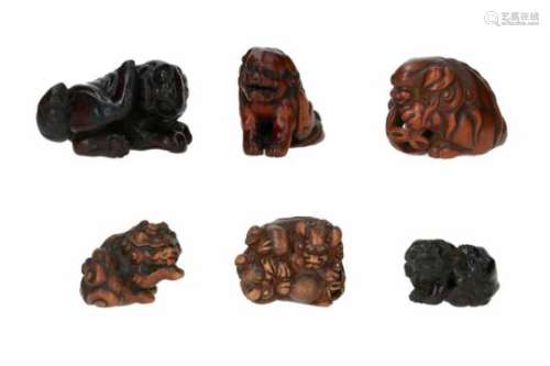 Lot of six netsuke, 1) wood, shishi licking his paw. Signed Sadanobu. H. 3 cm. 2) wood, shishi