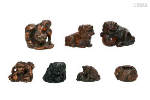 Lot of seven netsuke, 1) boxwood, shishi on rock. H. 4 cm. 2) wood, shishi with ball and cub.