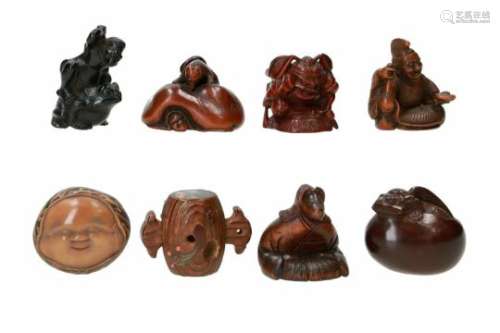 Lot of eight netsuke, 1) ebony wood, Tenjiku Tokubei on toad. Signed Nizan. H. 4 cm. 2) wood,