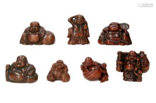 Lot of seven netsuke, 1) wood, sitting Hotei with fan. H. 3 cm. 2) wood, sitting Hotei with fly