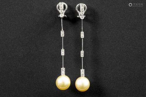 pair of earrings in white gold (18 carat) each with a pearl and diamonds - in total [...]