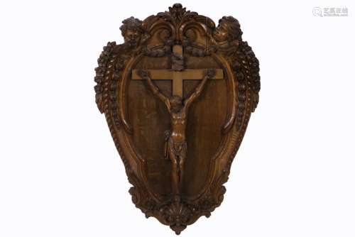 antique Christ's corpus on crest shape with Louis XV style ornamentation in oak - [...]