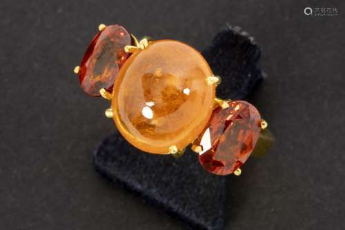 handmade ring in pink gold (18 carat) with a central fanta garnet spetite and two [...]
