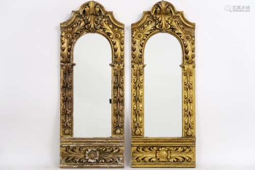 pair of mirrors each in an antique baroque style frame in guilded and sculpted wood [...]