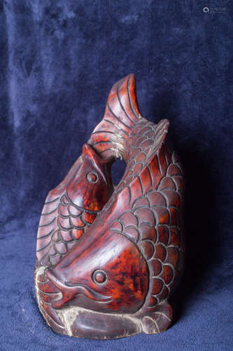 Wood sculpture of two fish