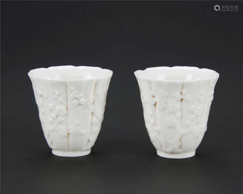A pair of Dehua white porcelain plum flower pattern cups