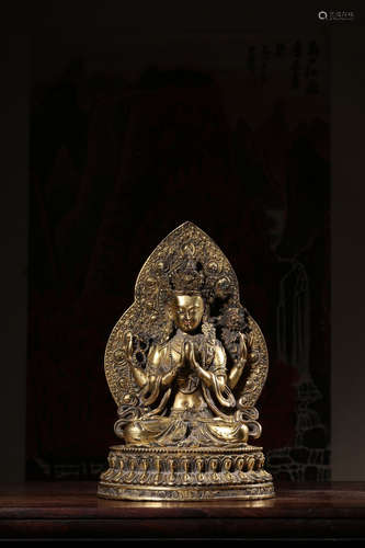 GILT BRONZE CAST FOUR-ARMED 'AVALOKITESHVARA' SEATED FIGURE WITH MANDORLA