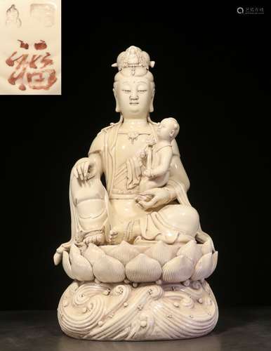 WHITE GLAZED AND CARVED 'GUANYIN' SEATED FIGURE