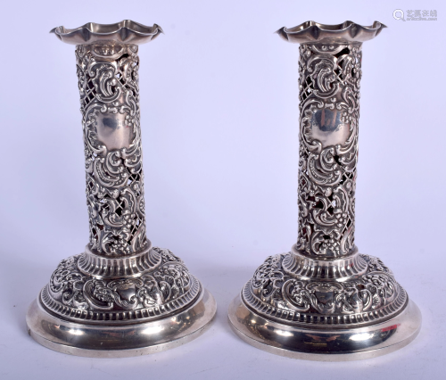 A PAIR OF ANTIQUE OPENWORK SILVER CANDLES…