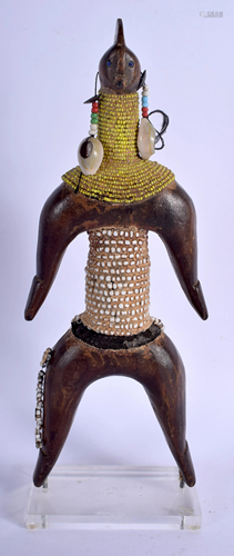 AN AFRICAN TRIBAL SHELL BEAD AND C STANDIN…