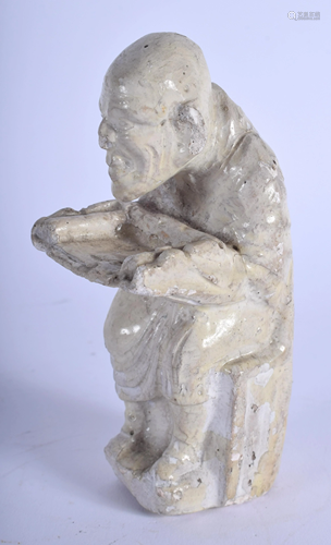 AN EARLY CHINESE FIGURE OF A SEATED MONK …