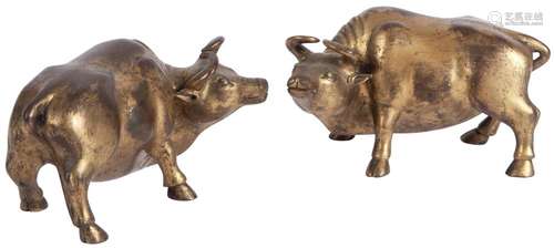 A Pair of Chinese Gilt Bronze Buffalo Late Ming/Early Qing Dynasty The mirrored pair of weights modeled with pleasant ex...