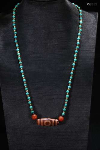 A Turquoise Stone Necklace With Dzi