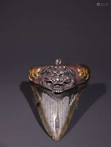 A Silver Pendant With Beast Carving