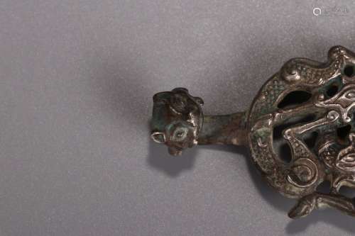 A Silver Pendant With Dragon Carving