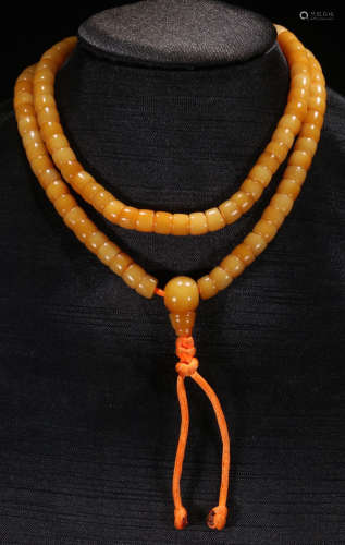A BONE STRING NECKLACE WITH 108 BEADS