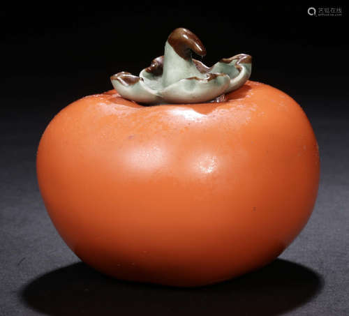 AN ORANGE GLAZE POT SHAPED WITH PERSIMMON