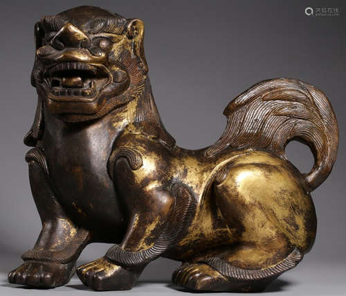 A GILT BRONZE LION ORNAMENT