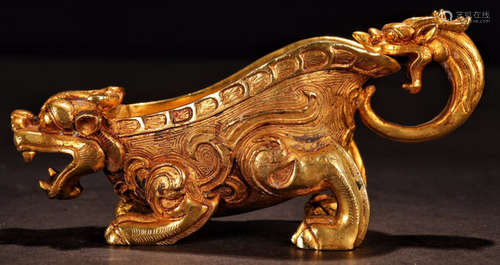 A GILT BRONZE CUP CARVED WITH BEAST