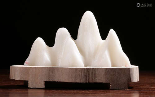 A STONE BRUSH HOLDER SHAPED WITH LANDSCAPE