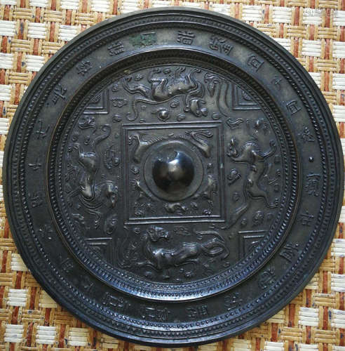 A COPPER MIRROR CARVED WITH BEAST PATTERN