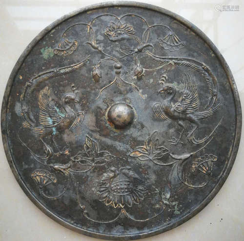 A COPPER MIRROR CARVED WITH PHOENIX PATTERN