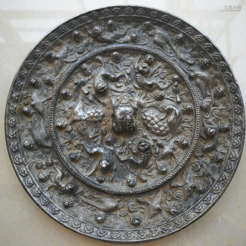 A COPPER MIRROR CARVED WITH BEAST PATTERN