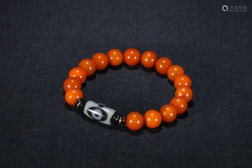 A Chinese Amber Bracelet With Dzi