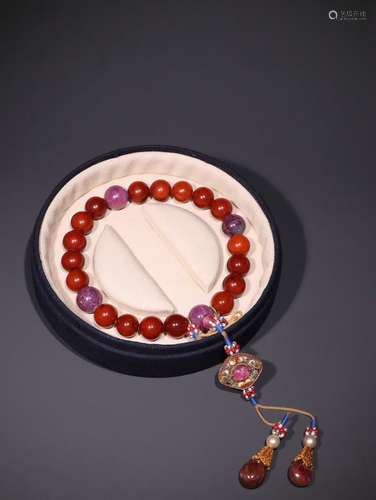 A Chinese Red Amber Bracelet With Ruby