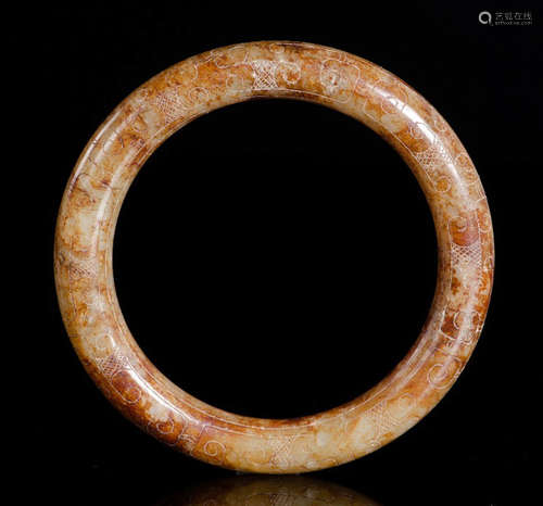 A HETIAN JADE BANGLE CARVED WITH BEAST PATTERN