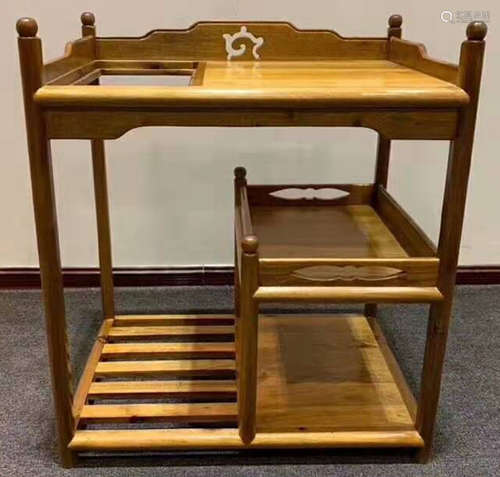 A GOLD NAN WOOD CABINET WITH DRAWERS