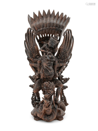 A Thai Carved Wood Figural Group of a Deity and …