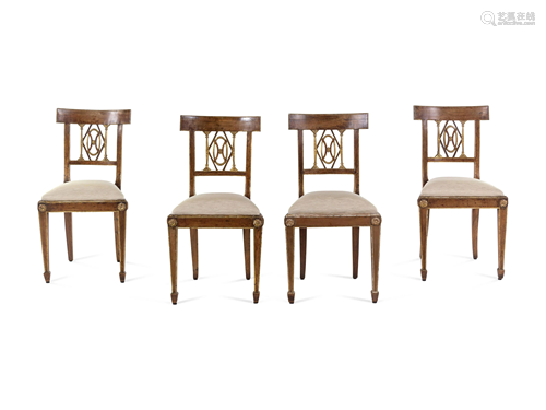 A Set of Four Regency Parcel Gilt Walnut Side Chairs