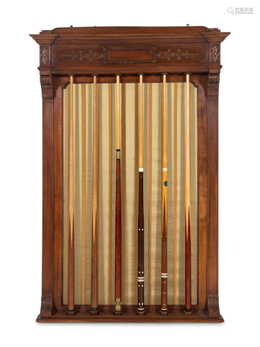 A Carved Walnut Billiards Cue Rack with a Set …