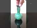 A small Roman hand blown turquoise glass decanter vessel