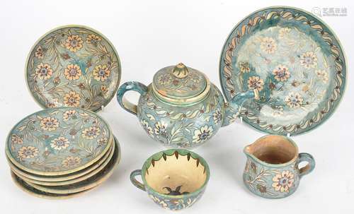 A Middle Eastern Palestine pottery part tea set, with floral Iznik style decoration on a blue glazed