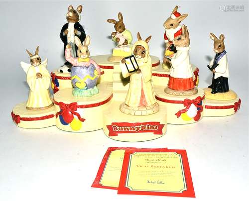 A small collection of Royal Doulton Bunnykins figures together with a Bunnykins resin display stand,