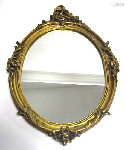 A giltwood framed oval mirror in the rococo style, length 66cm