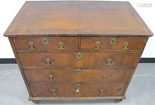 An 18th Century walnut chest, of two short above and the long graduated drawers, cross banded,